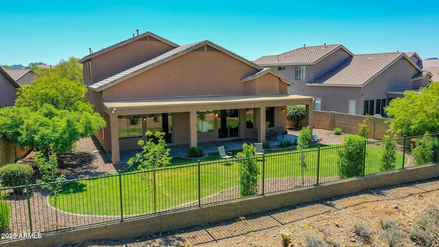 40814 N Majesty Ct, Anthem, AZ 85086 - view of front of home with stucco siding, a patio area, a fenced backyard, and a tiled roof