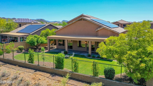 40814 N Majesty Ct, Anthem, AZ 85086 - view of front facade featuring solar panels, a fenced backyard, a patio area, and stucco siding