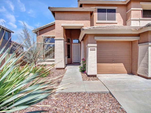 40814 N Majesty Ct, Anthem, AZ 85086 - view of front facade with stucco siding, driveway, an attached garage, and a tiled roof