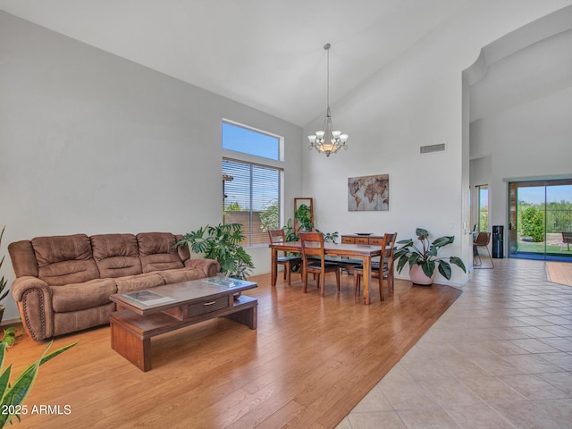 40814 N Majesty Ct, Anthem, AZ 85086 - living room featuring a chandelier, high vaulted ceiling, and healthy amount of natural light