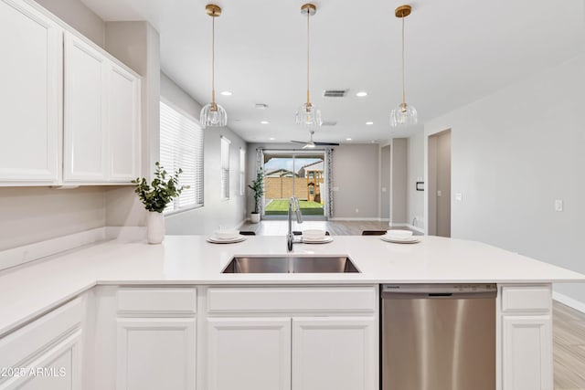 19958 W Turney Ave, Litchfield Park, AZ 85340 - kitchen featuring a peninsula, dishwasher, a sink, and white cabinets