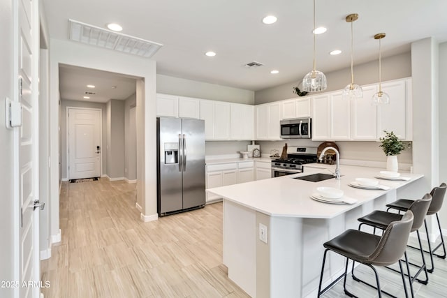 19958 W Turney Ave, Litchfield Park, AZ 85340 - kitchen with stainless steel appliances, a peninsula, visible vents, and a sink