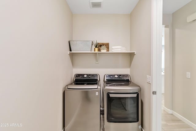 19958 W Turney Ave, Litchfield Park, AZ 85340 - clothes washing area featuring laundry area, baseboards, visible vents, and washer and clothes dryer