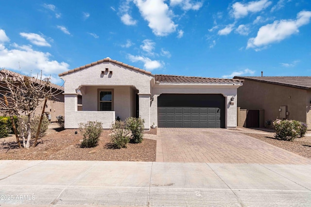 19958 W Turney Ave, Litchfield Park, AZ 85340 - mediterranean / spanish home with a garage, stucco siding, a tiled roof, and decorative driveway