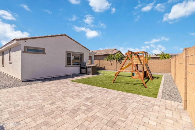 19958 W Turney Ave, Litchfield Park, AZ 85340 - rear view of property featuring a fenced backyard, stucco siding, a playground, and a patio area