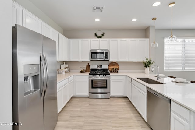 19958 W Turney Ave, Litchfield Park, AZ 85340 - kitchen featuring visible vents, white cabinetry, a sink, and appliances with stainless steel finishes