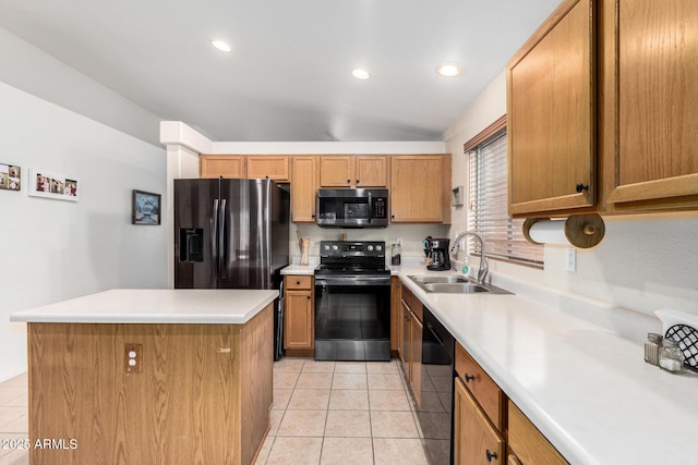 kitchen with a center island, stainless steel appliances, light countertops, light tile patterned flooring, and a sink