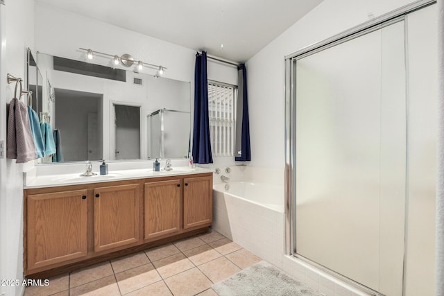 bathroom featuring a stall shower, a garden tub, a sink, and tile patterned floors