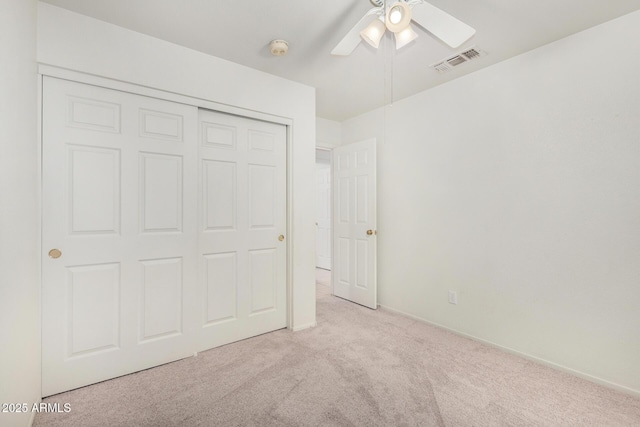 unfurnished bedroom with carpet floors, a closet, visible vents, and a ceiling fan