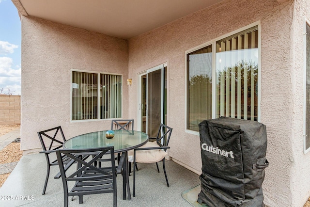 view of patio featuring outdoor dining area, fence, and grilling area