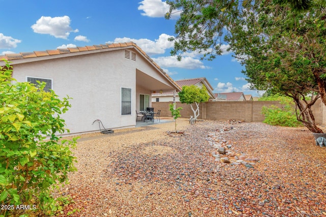 view of yard featuring fence and a patio