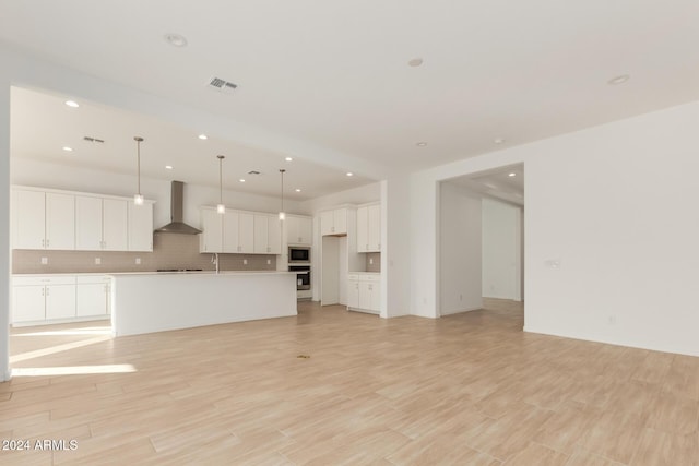 unfurnished living room with sink and light hardwood / wood-style flooring