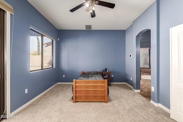 bedroom featuring arched walkways, ensuite bathroom, carpet floors, visible vents, and baseboards