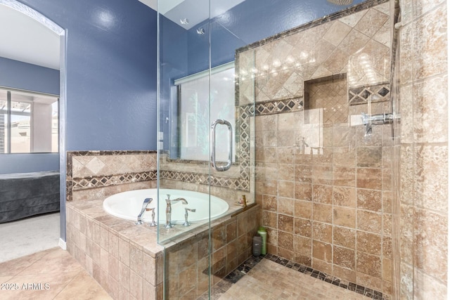 bathroom featuring a garden tub and a shower stall