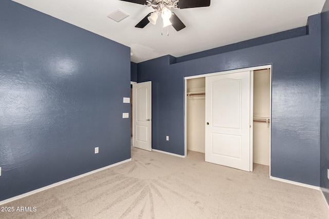 unfurnished bedroom with carpet, a closet, ceiling fan, and baseboards