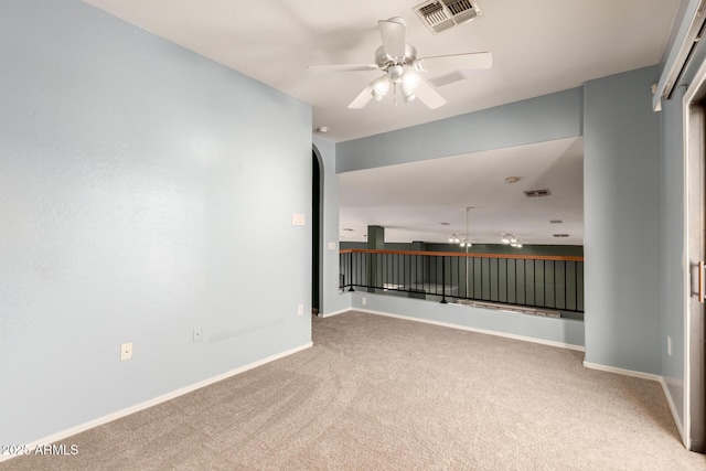 empty room featuring baseboards, carpet, visible vents, and a ceiling fan