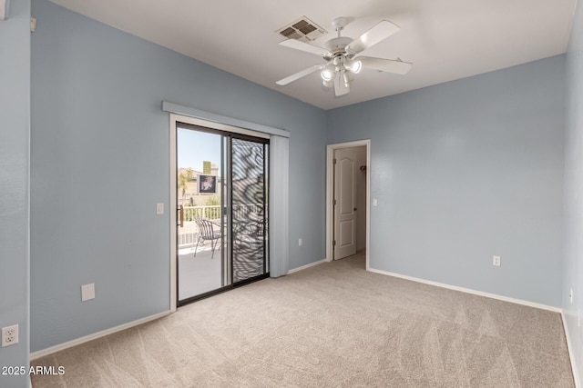 empty room featuring carpet floors, ceiling fan, visible vents, and baseboards