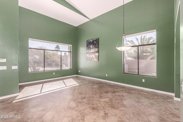 empty room featuring tile patterned flooring and baseboards