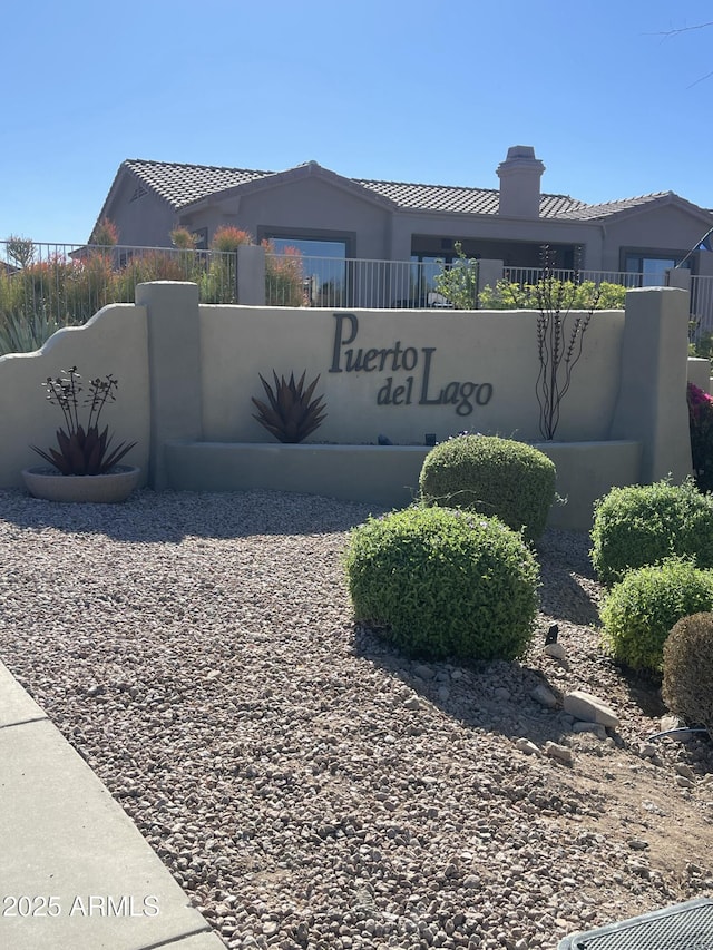 community / neighborhood sign featuring fence