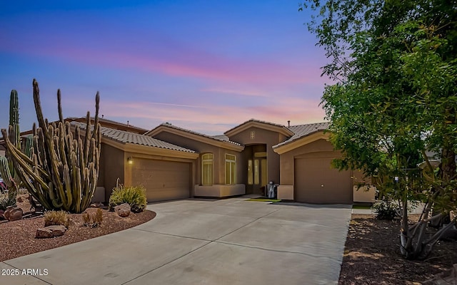 4667 E County Down Dr, Chandler, AZ 85249 - view of front of house with an attached garage, driveway, stucco siding, and a tile roof