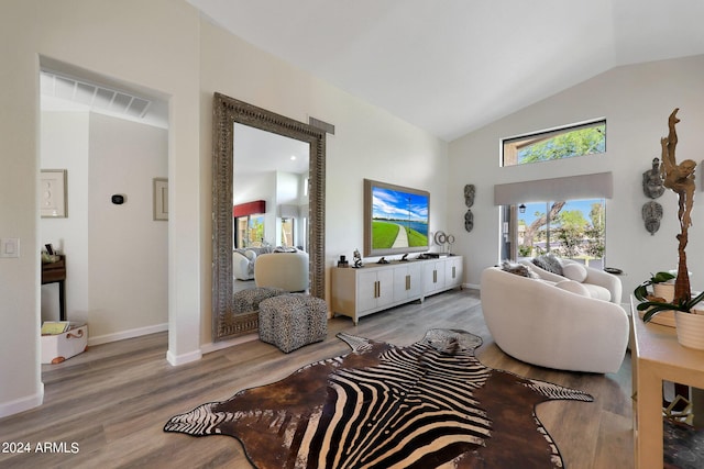 living room with hardwood / wood-style floors and vaulted ceiling