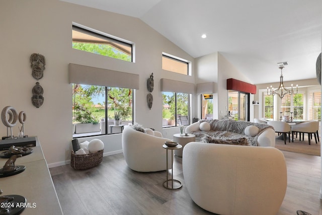 living room with a chandelier, hardwood / wood-style flooring, and high vaulted ceiling