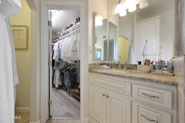 bathroom with hardwood / wood-style floors and vanity