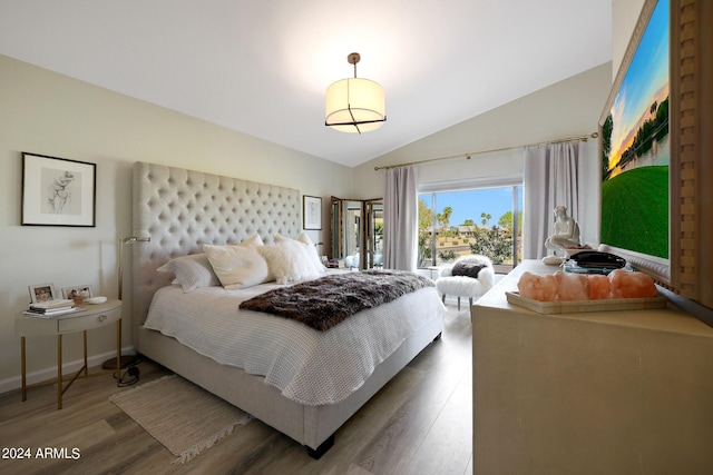 bedroom featuring vaulted ceiling and hardwood / wood-style flooring