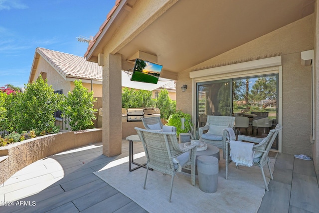 view of patio with area for grilling and a grill