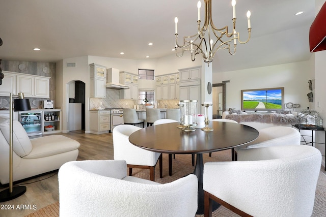 dining space featuring hardwood / wood-style flooring and a notable chandelier