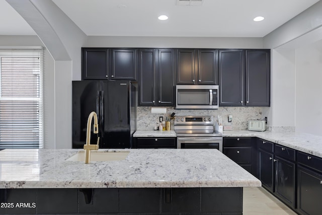 3687 E Leslie Dr, Gilbert, AZ 85296 - kitchen featuring stainless steel appliances, a sink, light stone countertops, tasteful backsplash, and recessed lighting