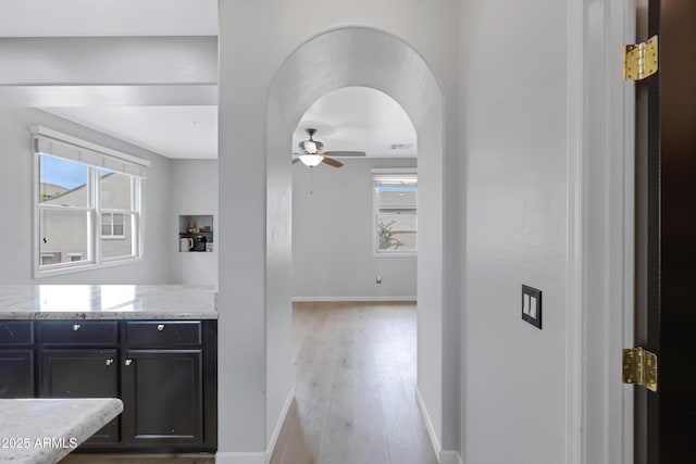 3687 E Leslie Dr, Gilbert, AZ 85296 - corridor featuring light wood-style flooring, baseboards, and arched walkways