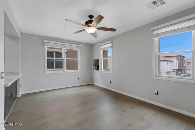 3687 E Leslie Dr, Gilbert, AZ 85296 - unfurnished room featuring baseboards, ceiling fan, and light wood-style flooring