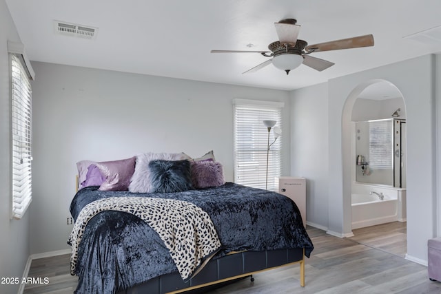 3687 E Leslie Dr, Gilbert, AZ 85296 - bedroom with baseboards, arched walkways, wood finished floors, and ceiling fan