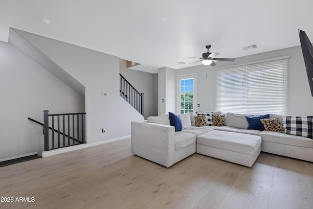 3687 E Leslie Dr, Gilbert, AZ 85296 - living area with light wood-type flooring, ceiling fan, baseboards, and stairway