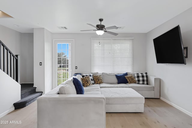 3687 E Leslie Dr, Gilbert, AZ 85296 - living room featuring stairs, ceiling fan, baseboards, and light wood-style floors