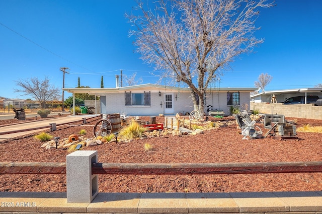 single story home featuring a carport and brick siding