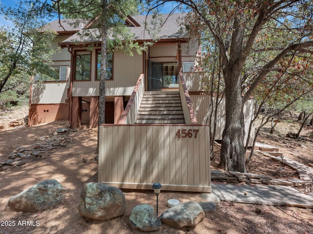 4567 N Juniper Ln, Pine, AZ 85544 - view of front of home featuring stairway and a shingled roof
