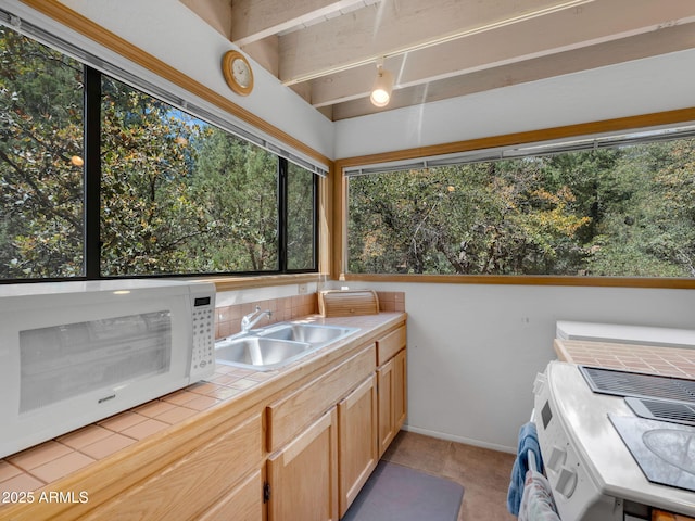 4567 N Juniper Ln, Pine, AZ 85544 - laundry room with a sink, light tile patterned floors, and separate washer and dryer