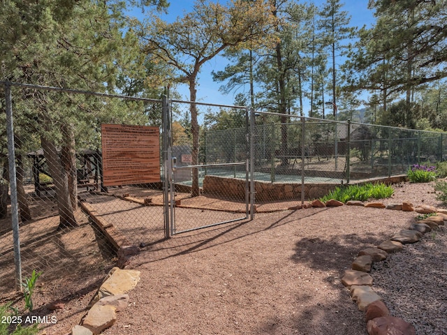 4567 N Juniper Ln, Pine, AZ 85544 - view of yard featuring a gate and a tennis court