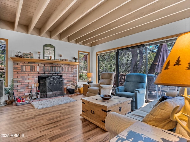 4567 N Juniper Ln, Pine, AZ 85544 - living area with beamed ceiling, wood finished floors, healthy amount of natural light, and a brick fireplace