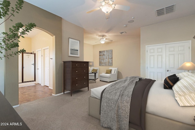 carpeted bedroom featuring ceiling fan and a closet