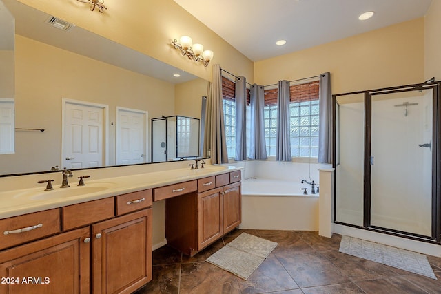 bathroom with vanity and separate shower and tub