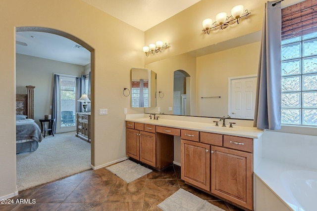 bathroom featuring a tub to relax in and vanity