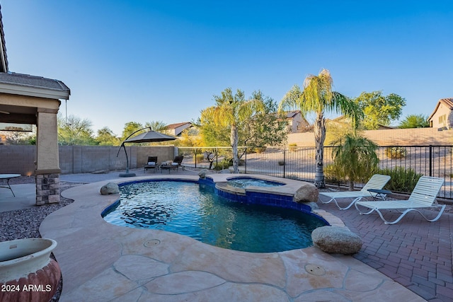 view of swimming pool with an in ground hot tub and a patio