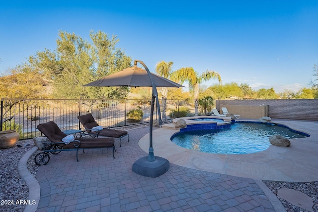 view of pool featuring an in ground hot tub and a patio