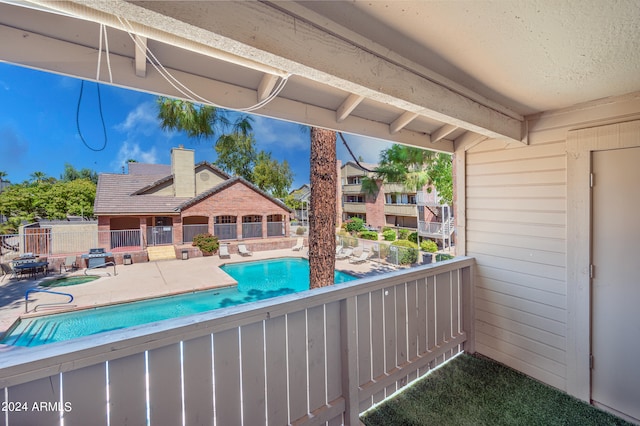 pool featuring fence and a patio area
