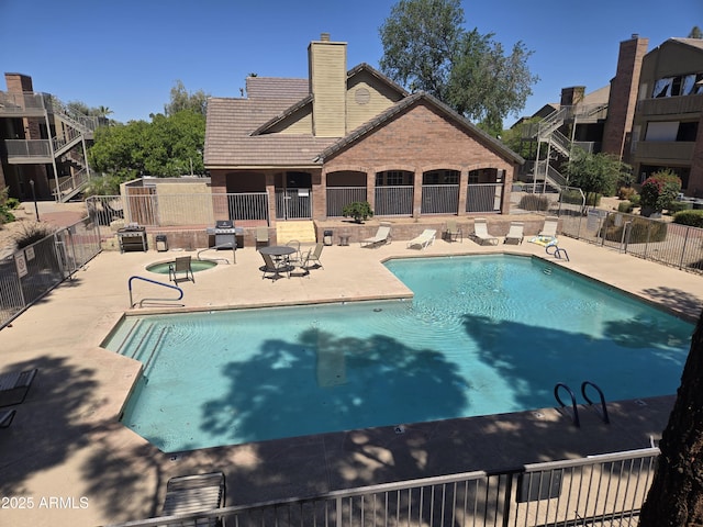 community pool featuring a patio area and fence
