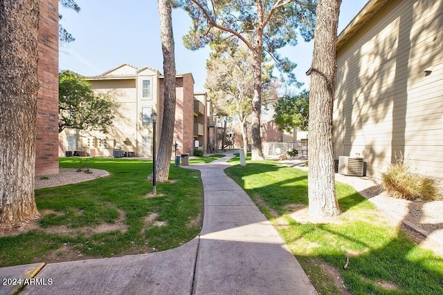 view of property's community with a lawn
