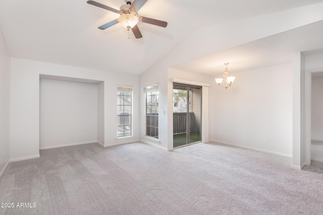 unfurnished room with carpet, lofted ceiling, baseboards, and ceiling fan with notable chandelier